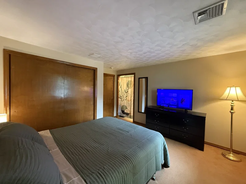 Room 1 — Reverse View with Closet, Dresser & TV